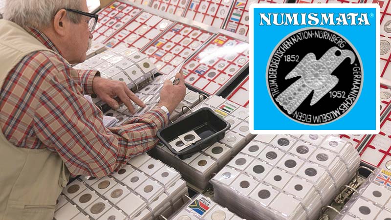 A collector searches binders of coins at the Numismata Show in Munich earlier this month